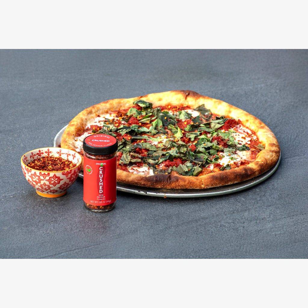 Original Crushed Red Pepper Flakes on a Margarita pizza on a slate table
